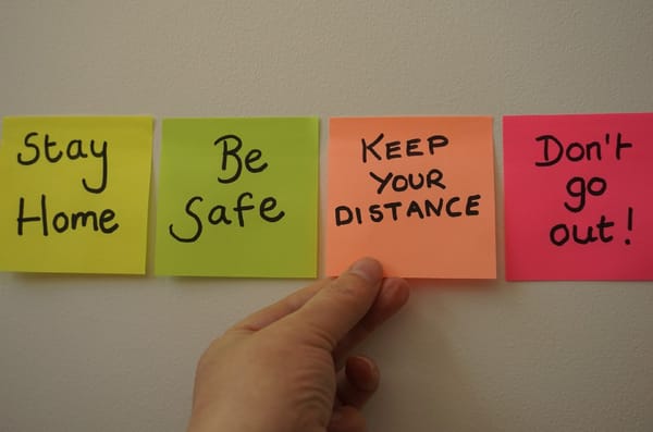 Several postit notes with notes like "be safe," and "Don't go out!"